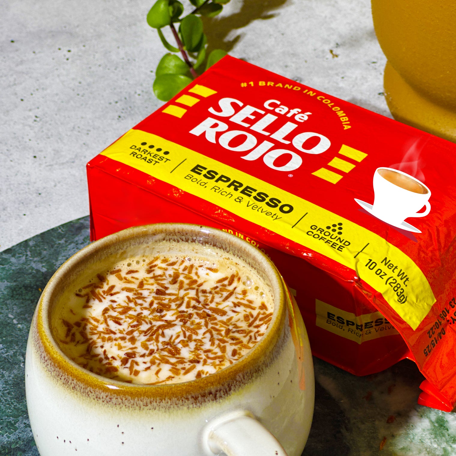 Café Sello Rojo espresso box with a cup of coffee on a textured surface
